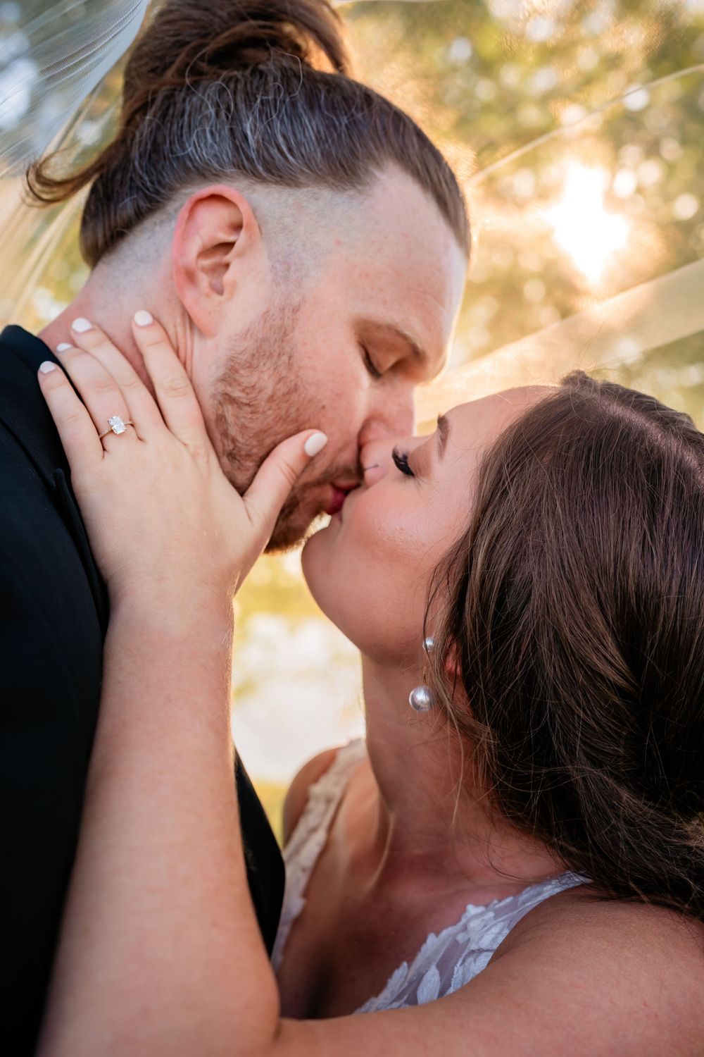 A romantic series of closeup shots showing a tender kiss sequence between two people during golden hour.