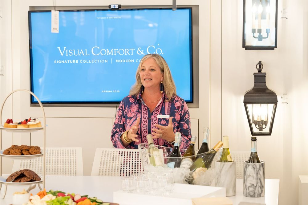 Professional networking event with refreshments and displays in a bright modern space.