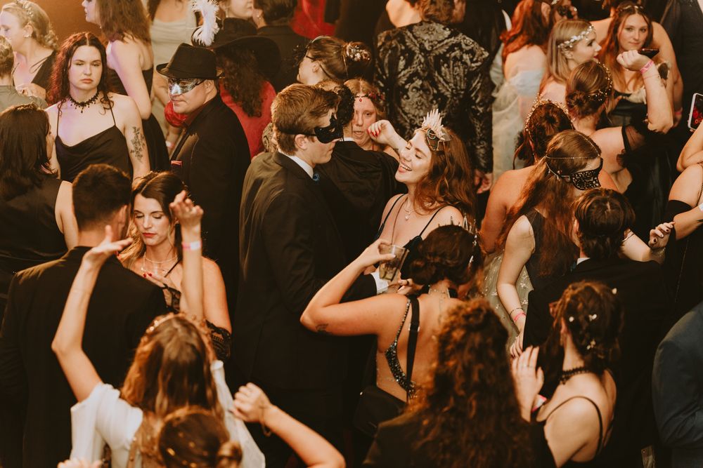 Crowded dance floor with party-goers enjoying live entertainment.
