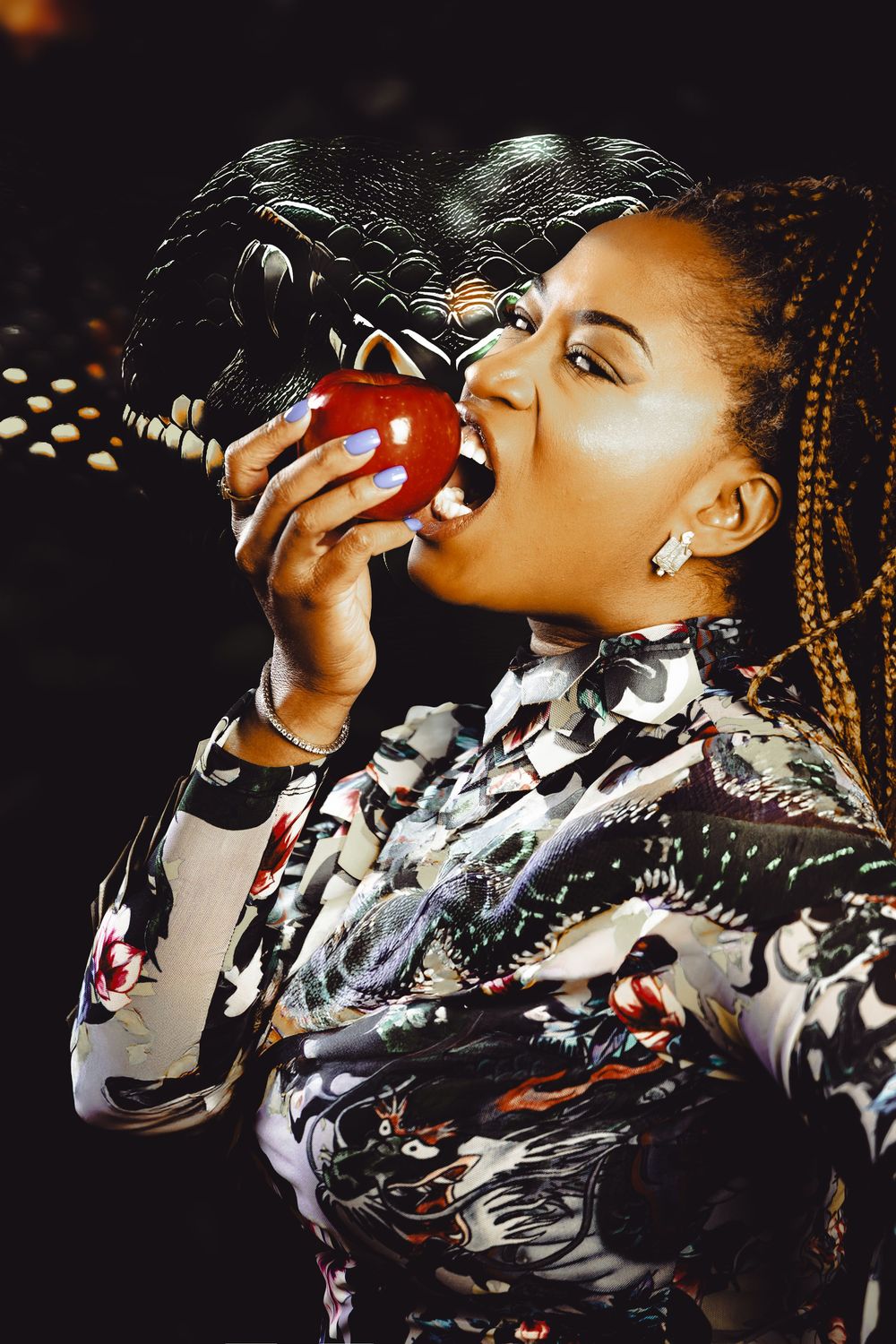 A performer in a patterned jacket sings passionately into a microphone during a dramatic stage performance.