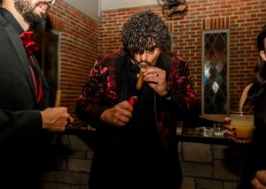 Wedding reception detail shots in a brick-walled venue with moody lighting.