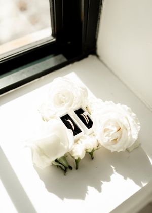White roses arranged on a bright windowsill creating a minimalist composition.