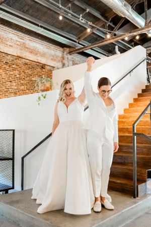 Modern industrial venue photoshoot featuring white outfits and architectural elements.