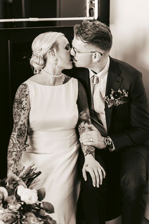 A vintage-style portrait of a couple in elegant wedding attire.