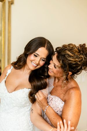Emotional moment shared between two people in formal wedding attire.