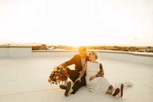 Dreamy waterfront wedding photos at golden hour with flowing white dress.