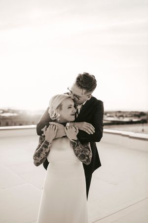 Black and white romantic portraits of a couple embracing on their wedding day.