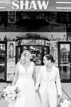Black and white wedding portraits taken outside urban storefront.