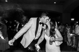 A couple shares a romantic dance moment at their wedding reception in black and white.