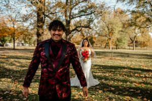 Autumn wedding photography session with fall foliage in background.