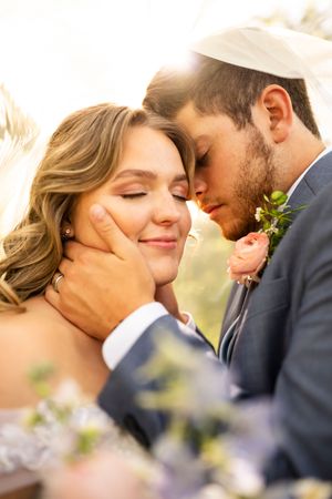 Intimate close-up wedding portraits with soft natural lighting and floral details.