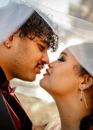 Intimate wedding moment captured in soft lighting with delicate details.