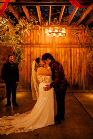 Wedding celebration in a rustic barn venue with warm lighting and wooden details.