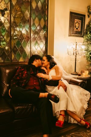 Romantic wedding portraits in an elegant room with diamond-patterned walls and vintage decor.