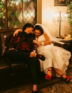 Intimate wedding photos on vintage furniture with warm ambient lighting.