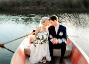 Artistic waterfront wedding photography sequence in a vintage wooden boat.