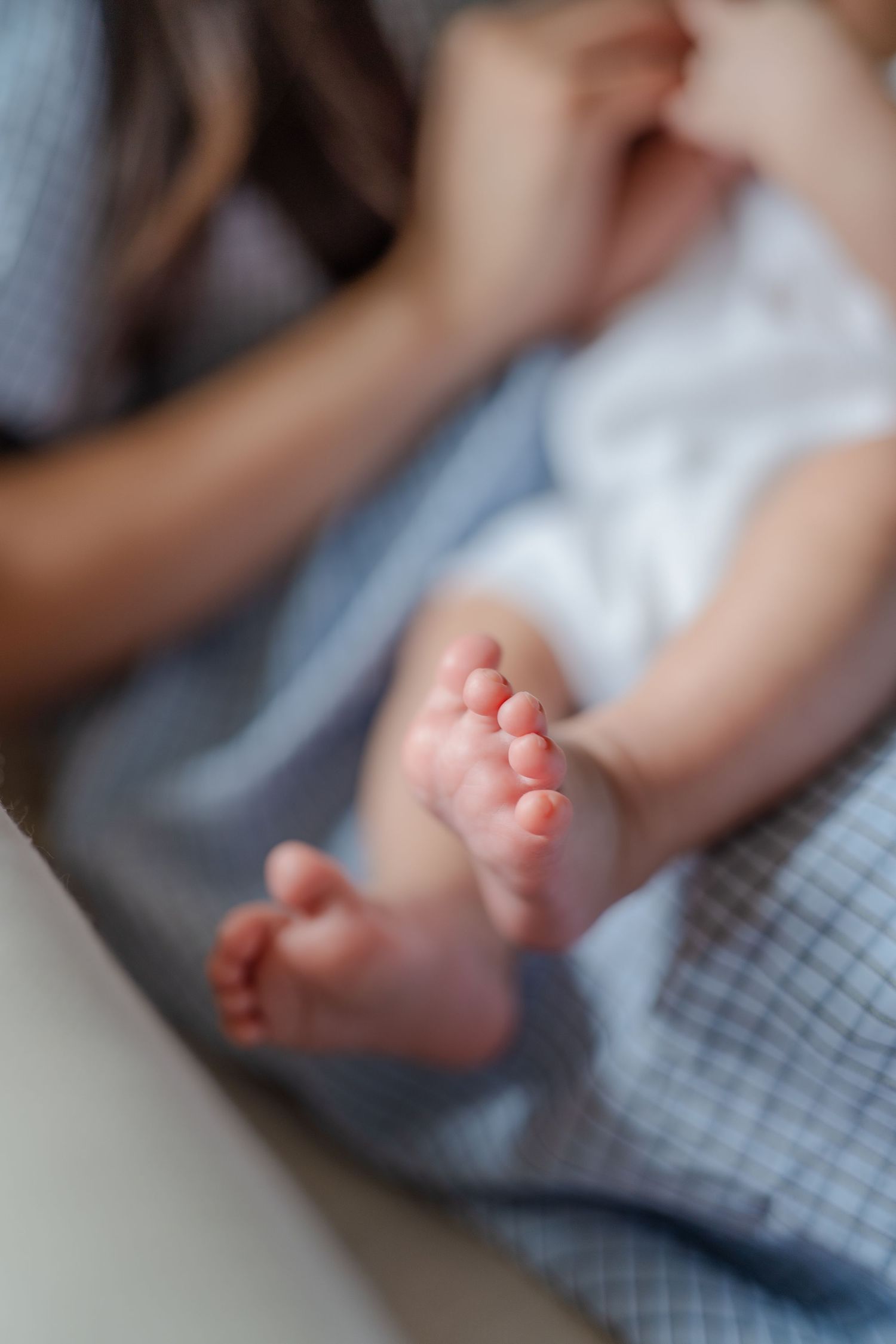 Newborn baby toes, mom holding baby