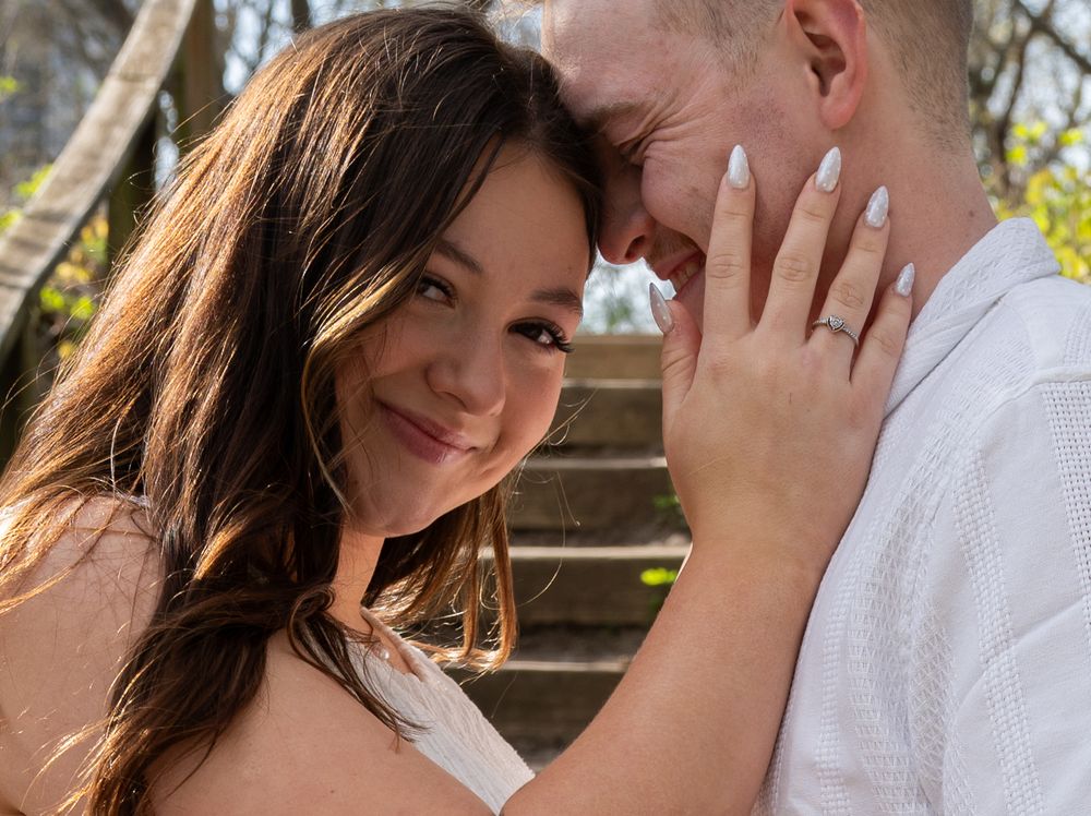 Male/female couple, female looking at camera, male touching forehead to female's temple
