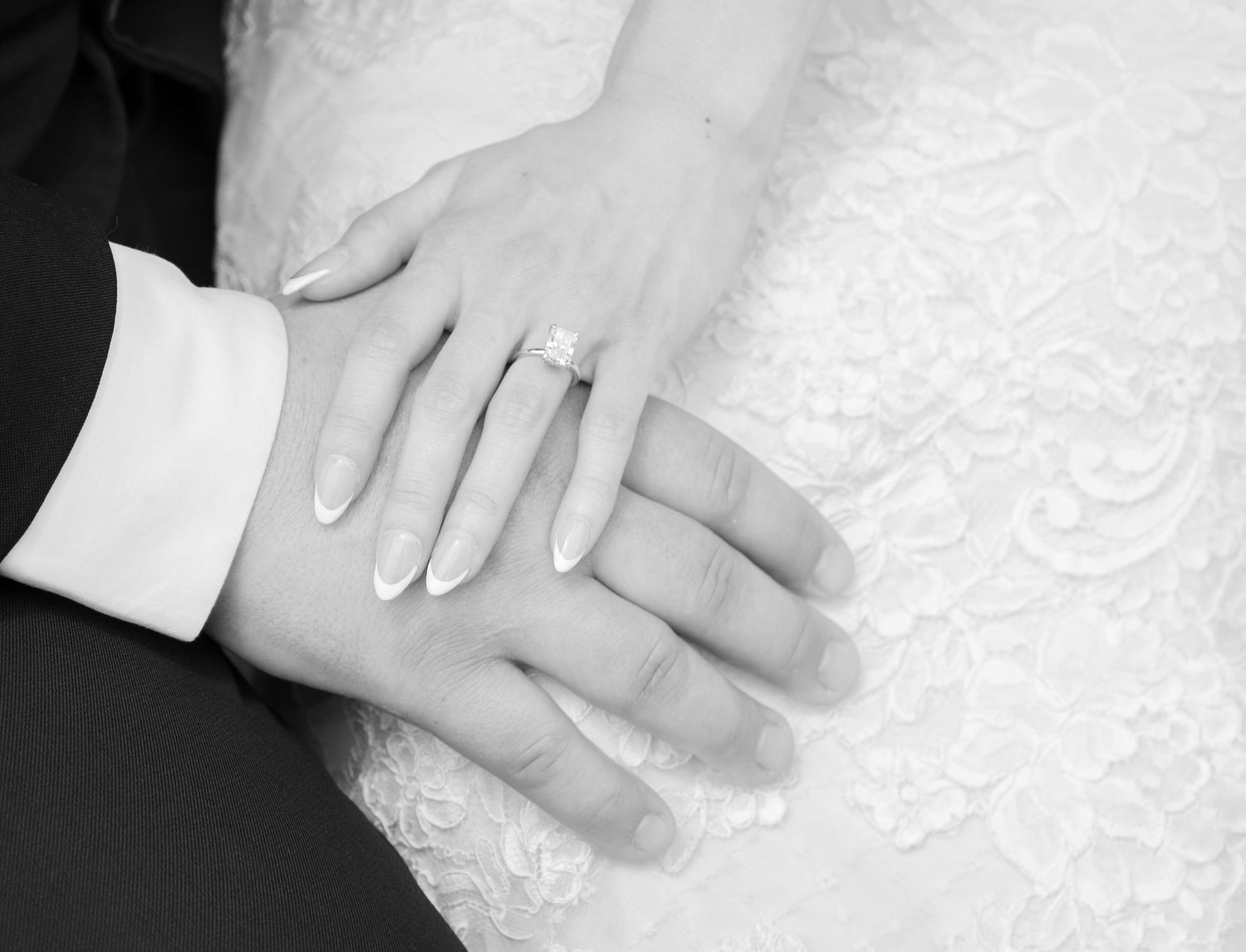 Detail shot of wedding rings on bride and groom’s hands.