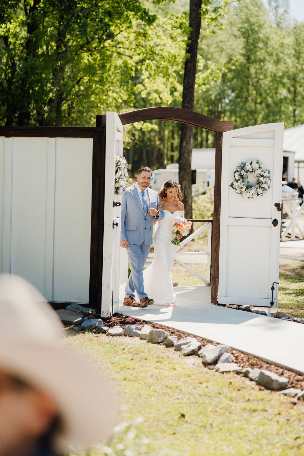 Romantic wedding photo at The English Country Barn of the Carolinas featuring a couple in soft spring light. Photo and Video team.