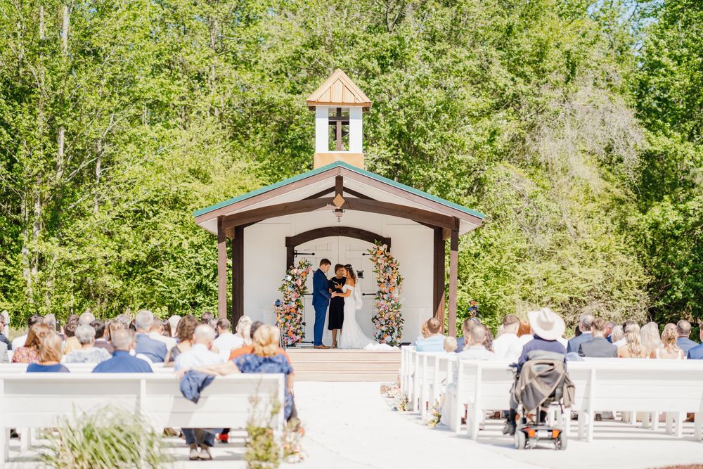 Romantic wedding photo at The English Country Barn of the Carolinas featuring a couple in soft spring light. Photo and Video team.