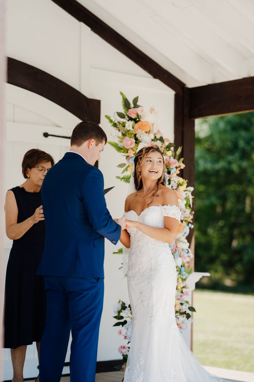 Romantic wedding photo at The English Country Barn of the Carolinas featuring a couple in soft spring light. Photo and Video team.