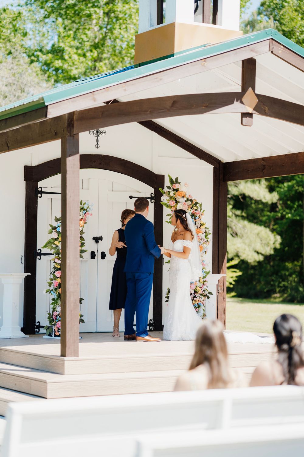 Romantic wedding photo at The English Country Barn of the Carolinas featuring a couple in soft spring light. Photo and Video team.