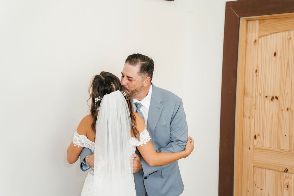 Romantic wedding photo at The English Country Barn of the Carolinas featuring a couple in soft spring light. Photo and Video team.