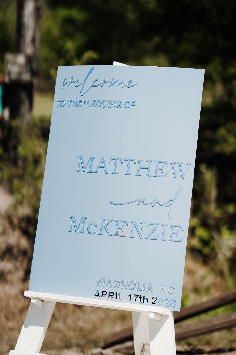 Romantic wedding photo at The English Country Barn of the Carolinas featuring a couple in soft spring light. Photo and Video team.