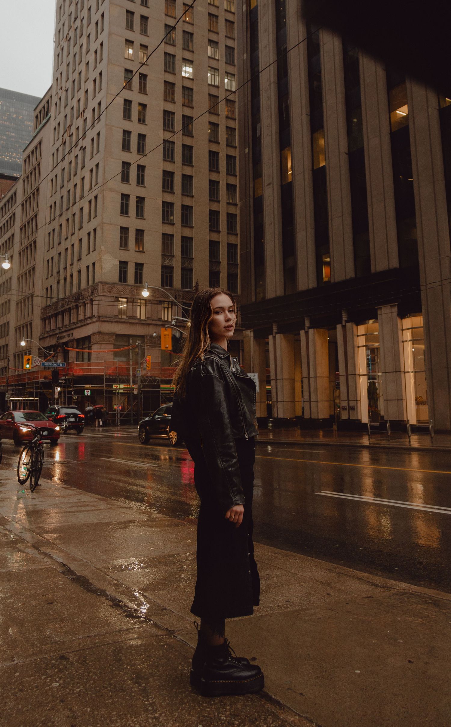 Model standing on street during raining evening in Toronto.