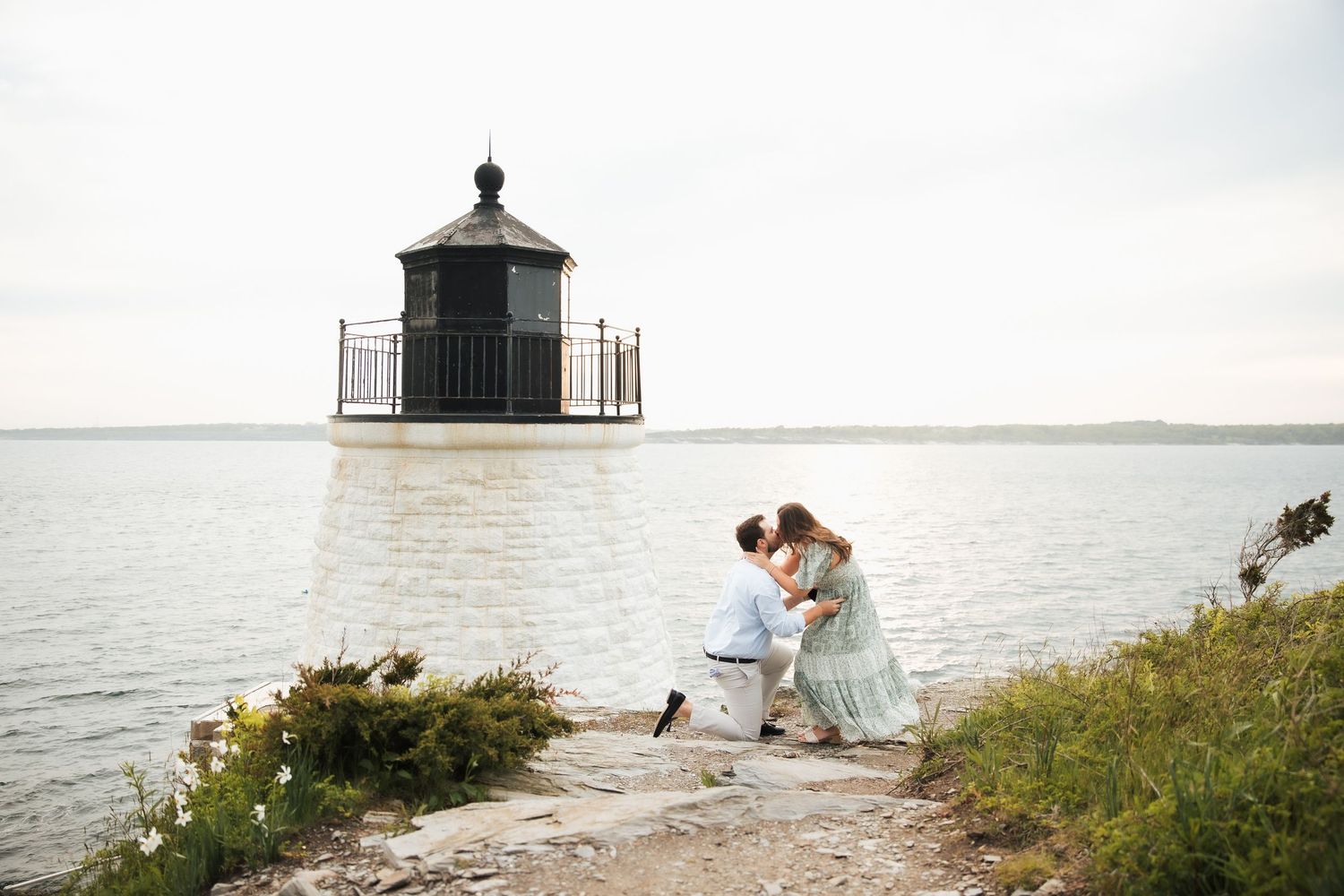 Couple sharing a romantic proposal moment at castle hill, Newport Rhode Island