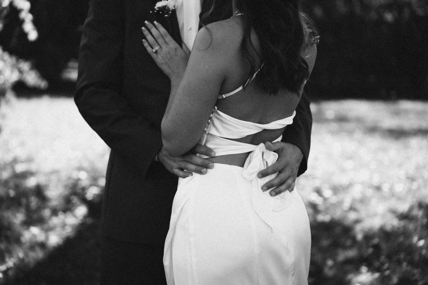 A couple in formal wedding attire holds hands during an intimate outdoor ceremony. Located in Dayton, Ohio.