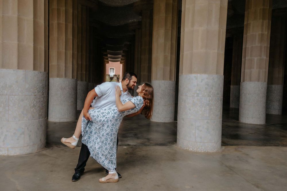 Childhood friends turned fiancés laughing together in Barcelona.