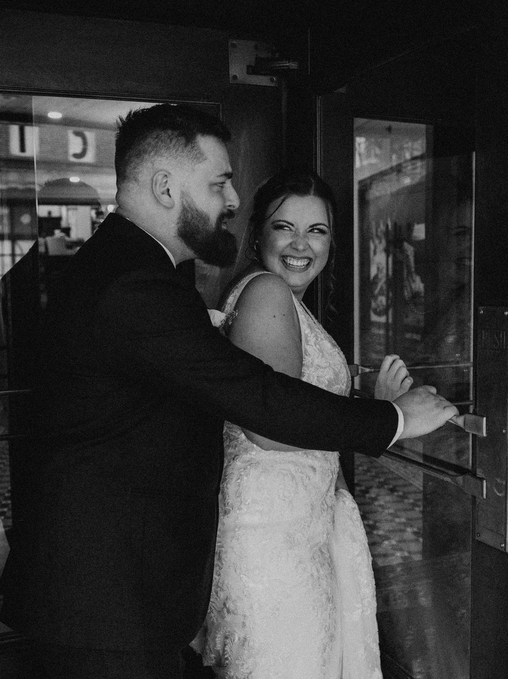 Bride and groom portrait at revolving door of the Yorktowne Hotel  wedding in York PA– elegant winter wedding