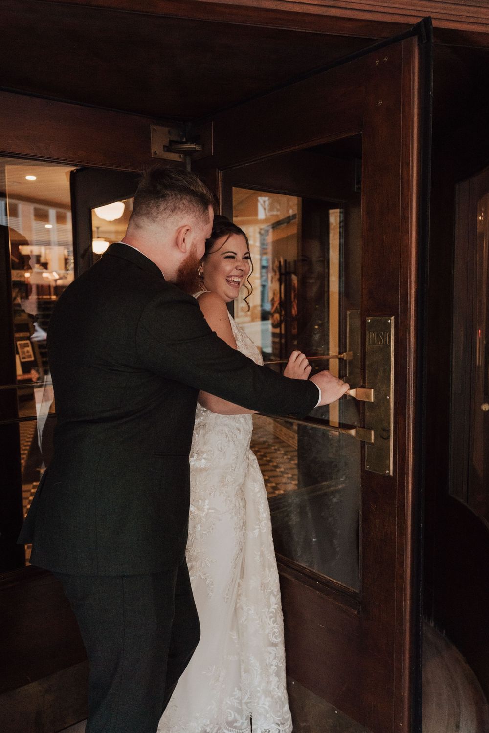 Bride and groom portrait at revolving door of the Yorktowne Hotel  wedding in York PA– elegant winter wedding