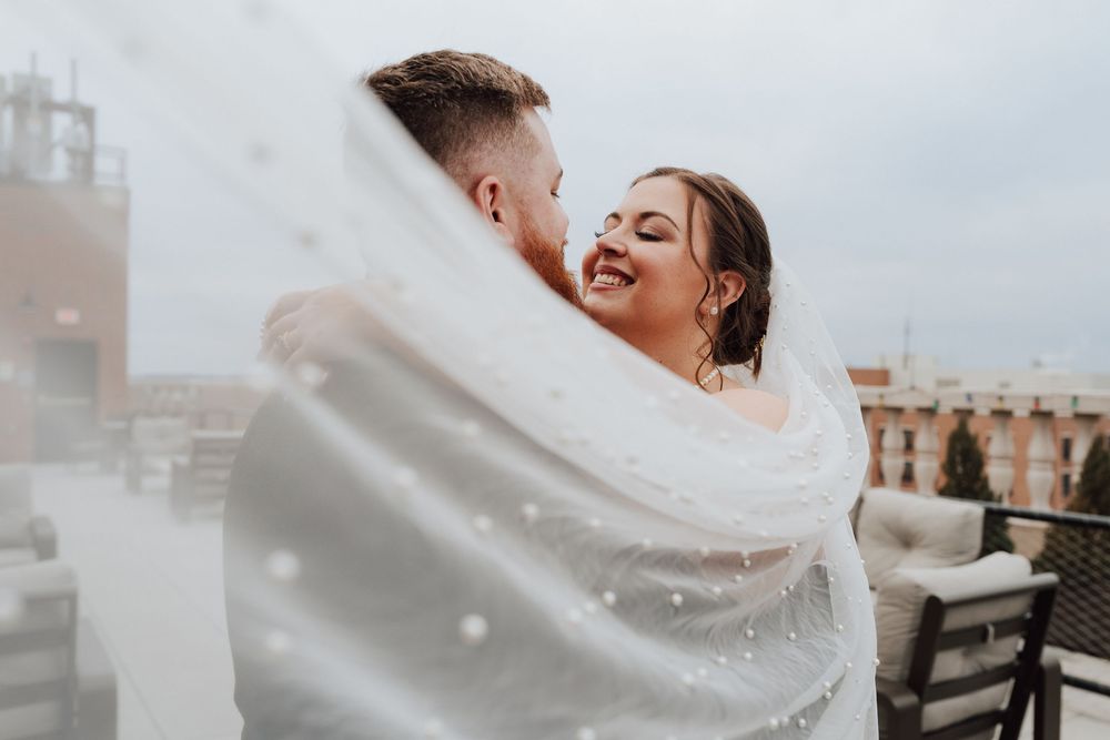 Bride and groom portrait at rooftop of the Yorktowne Hotel  wedding in York PA– elegant winter wedding
