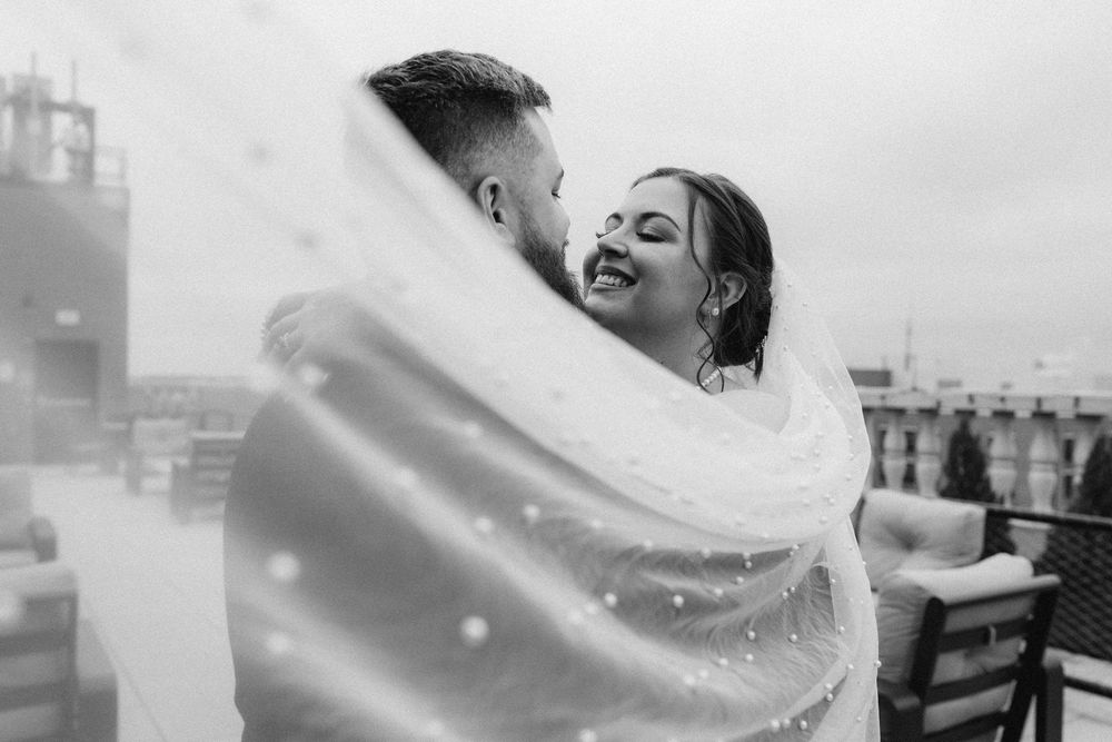 Bride and groom portrait under veil at rooftop of the Yorktowne Hotel  wedding in York PA– elegant winter wedding