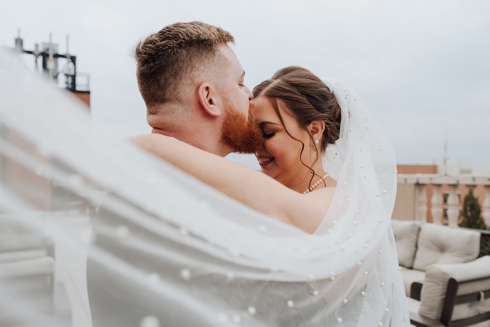 Bride and groom portrait at rooftop of the Yorktowne Hotel  wedding in York PA– elegant winter wedding