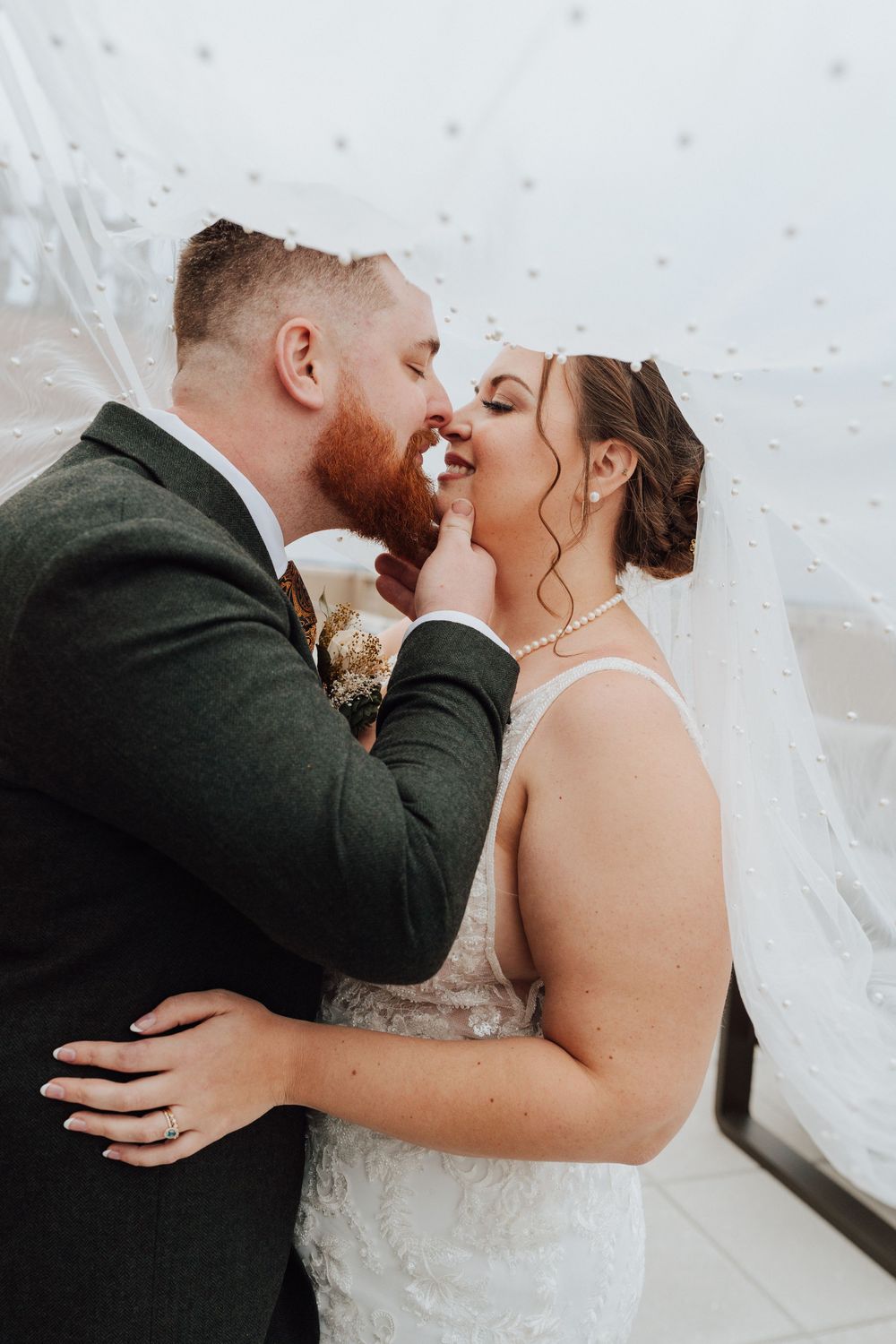 Bride and groom portrait at rooftop of the Yorktowne Hotel  wedding in York PA– elegant winter wedding
