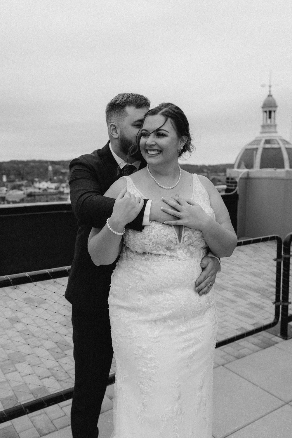 Bride and groom portrait at rooftop of the Yorktowne Hotel  wedding in York PA– elegant winter wedding