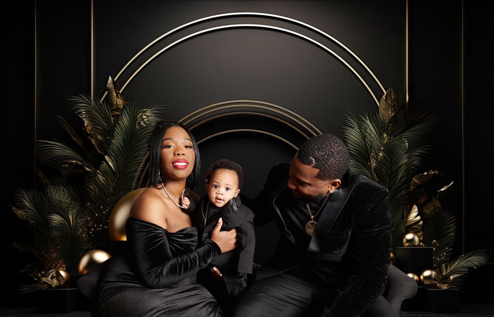 Stylish portrait with black and gold decor featuring elegant formal attire.