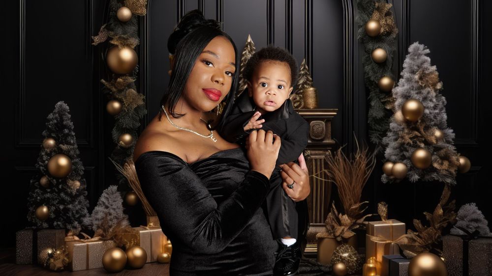 Glamorous holiday portrait with Christmas trees and gold ornaments in background.