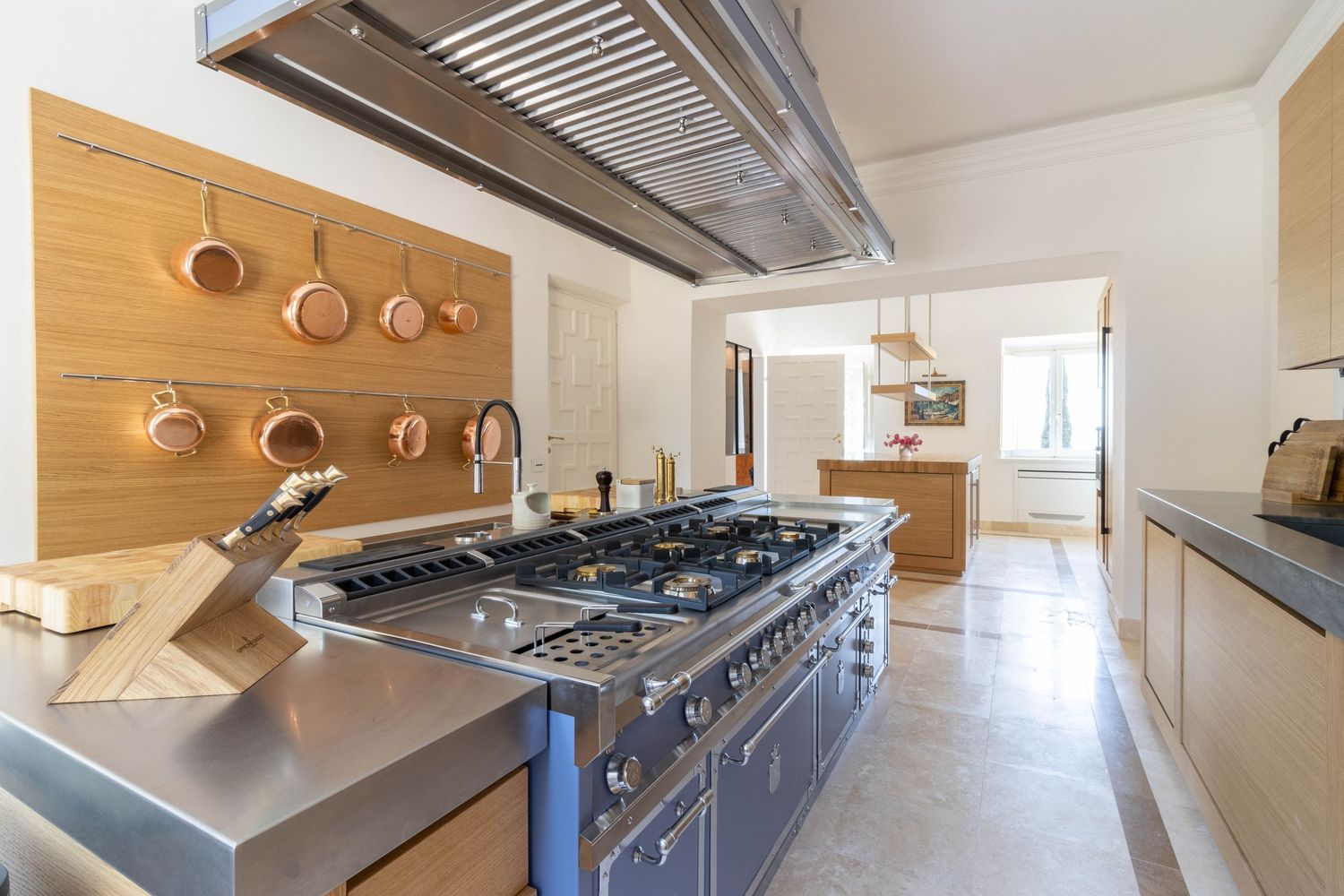 Luxury Tuscan villa interior photography in Chianti. Modern kitchen interior with stainless steel appliances, pendant lighting.