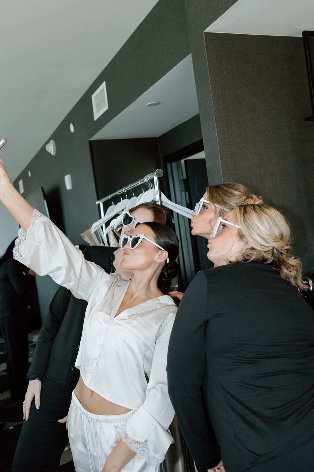Wedding party members celebrating in casual getting-ready attire.