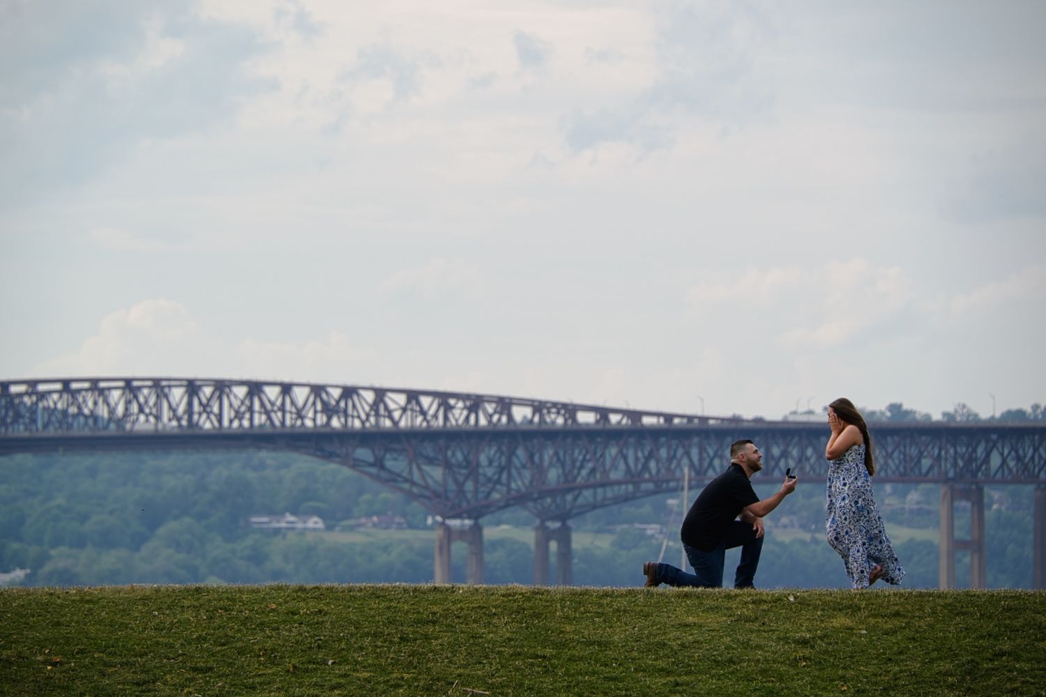 A sequence of silhouettes on a bridge against a cloudy sky, showing a person performing backflips and acrobatic moves.