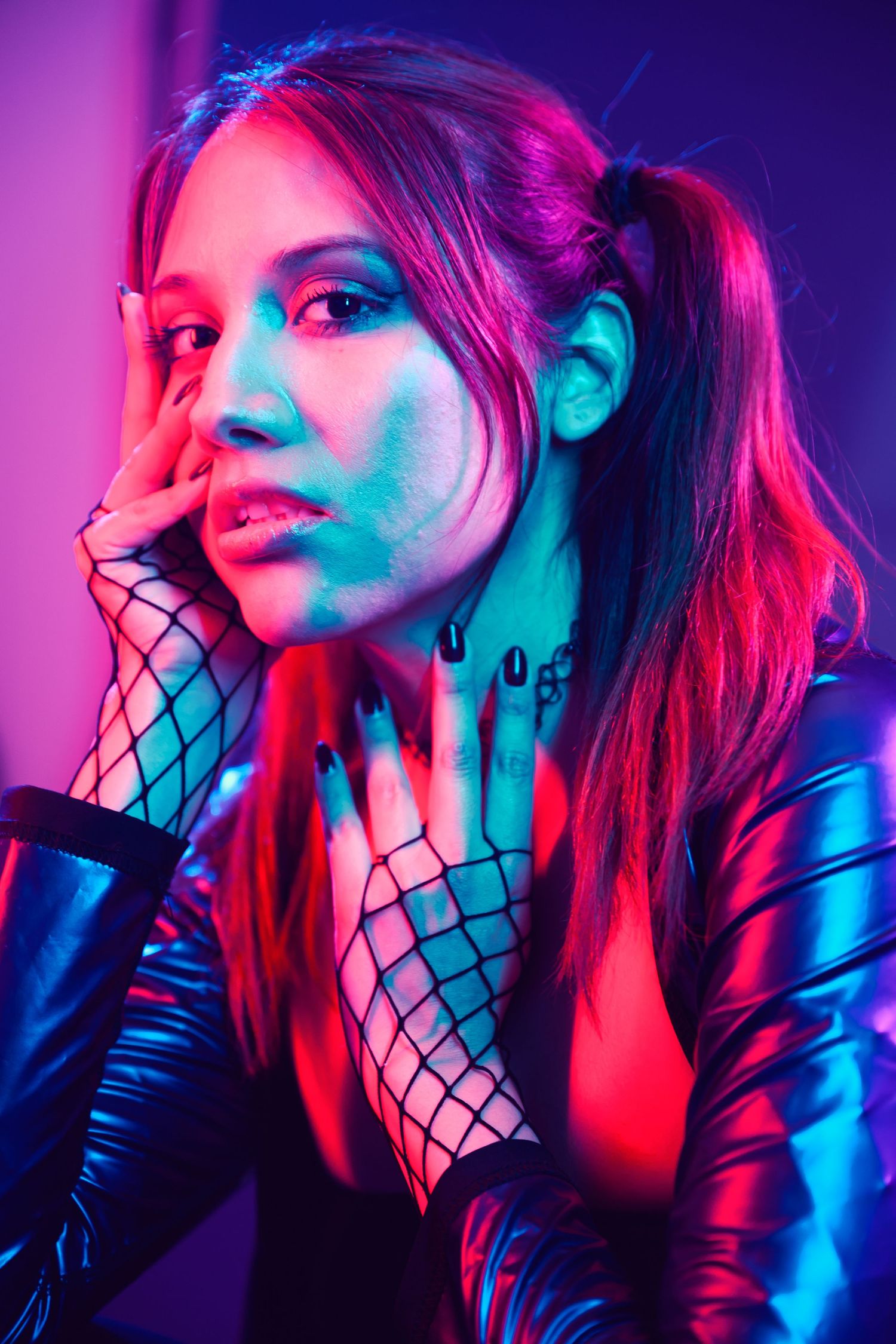 Artistic portrait series with neon red and blue lighting showing dramatic poses against dark background with fishnet details.