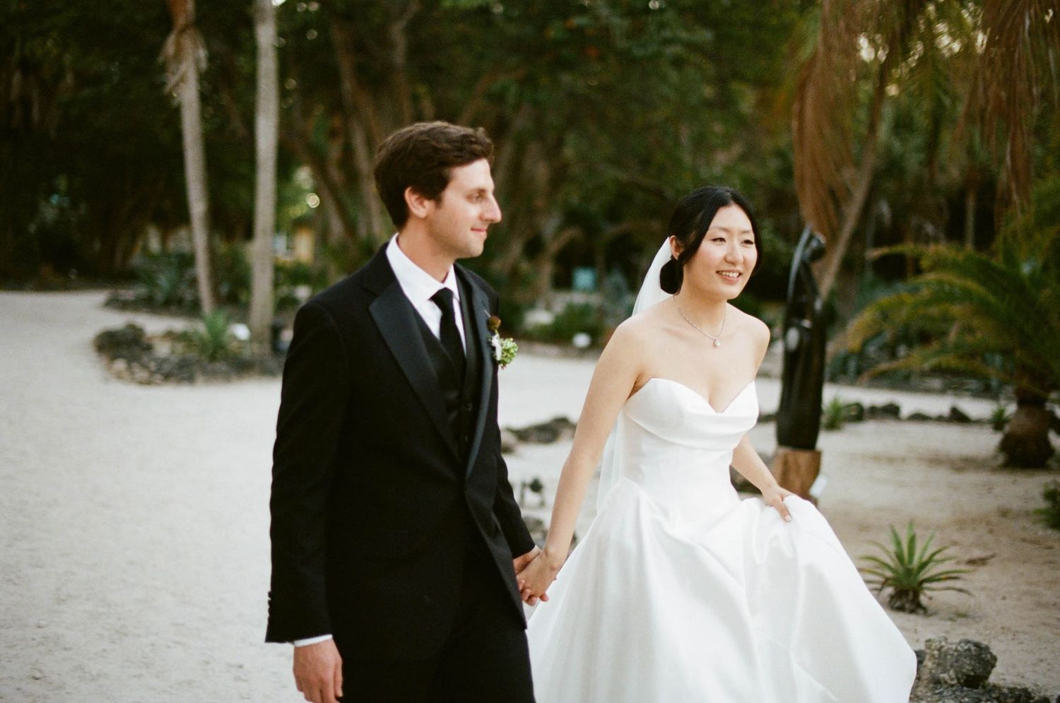 Wedding photos taken on rustic stone steps under Spanish moss draped trees in a romantic garden setting.