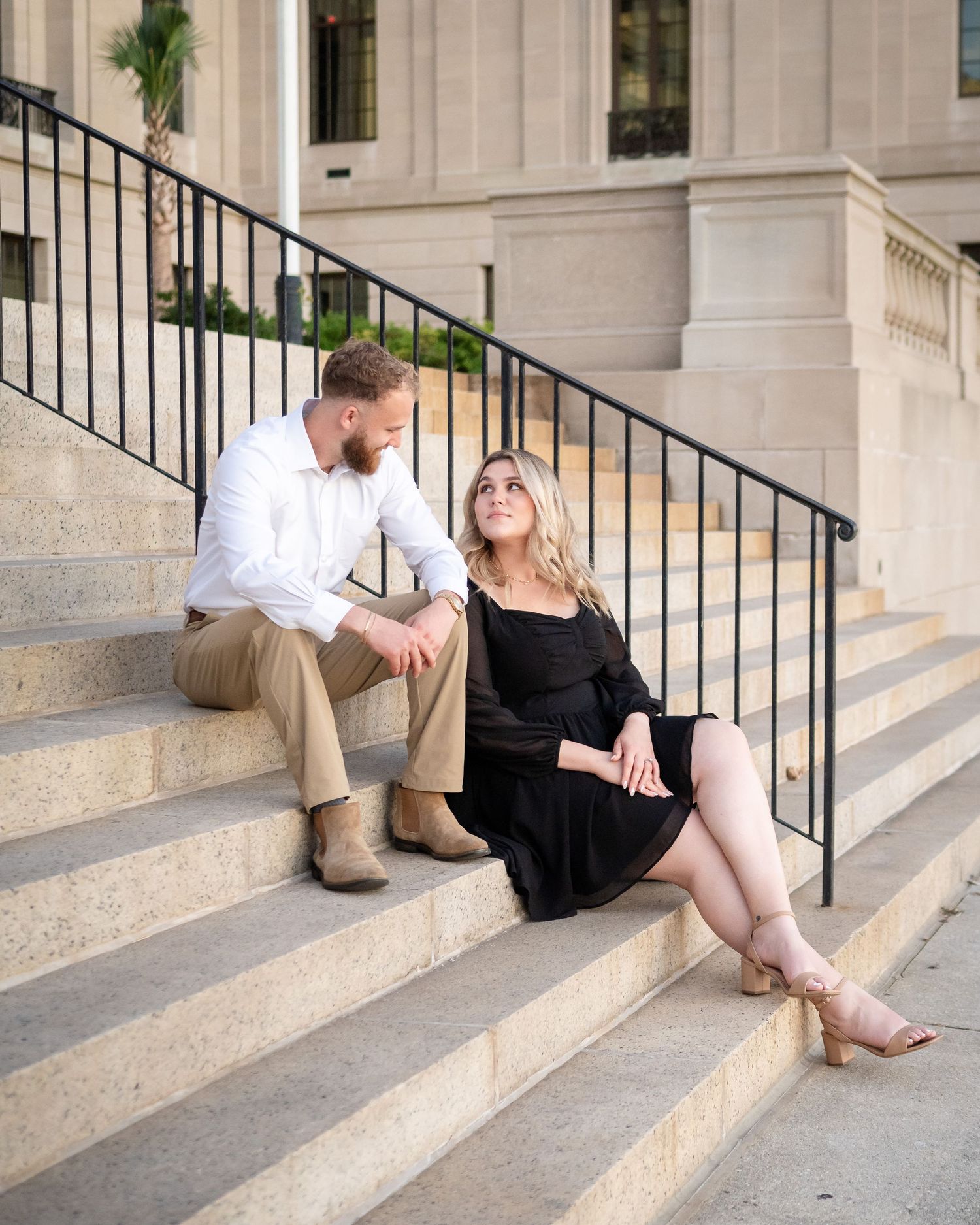 A series of romantic engagement photos showing a couple sitting on stone steps in casual attire.