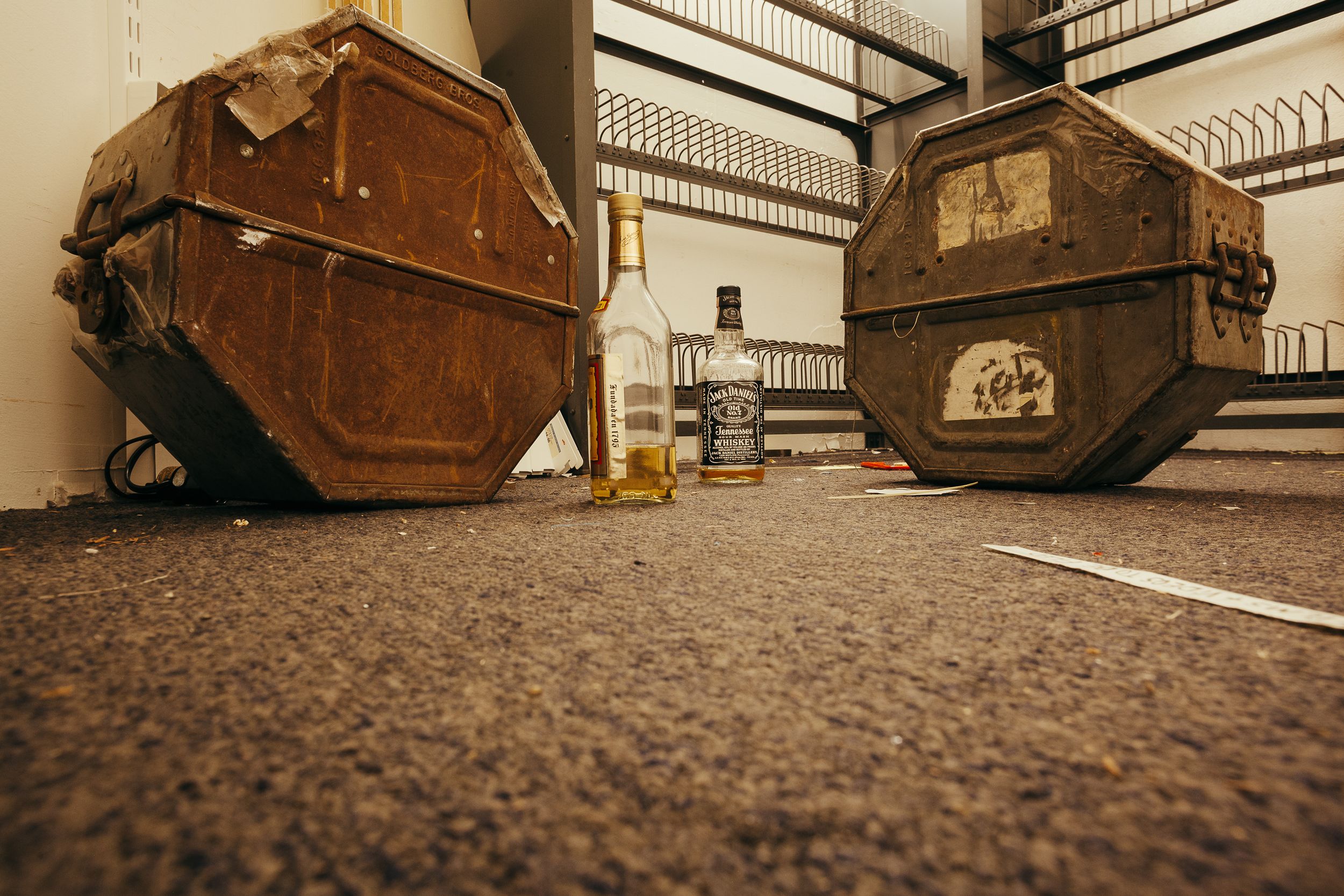 Low angle view of wooden benches or seating with textured flooring in foreground.