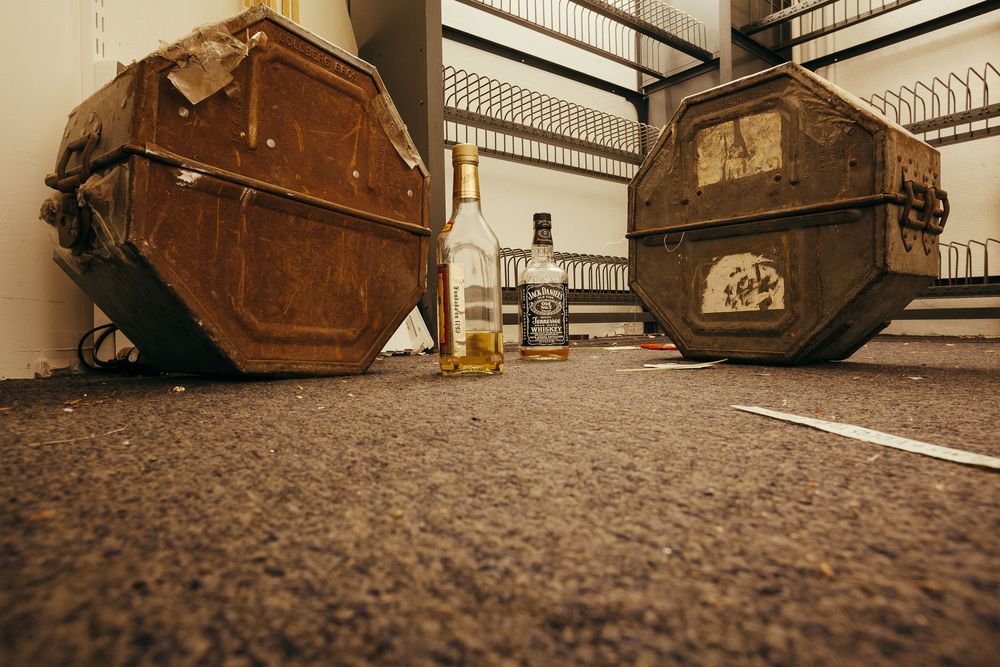 Low angle view of wooden benches or seating with textured flooring in foreground.